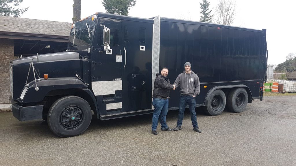 armatus owners in front of armoured truck
